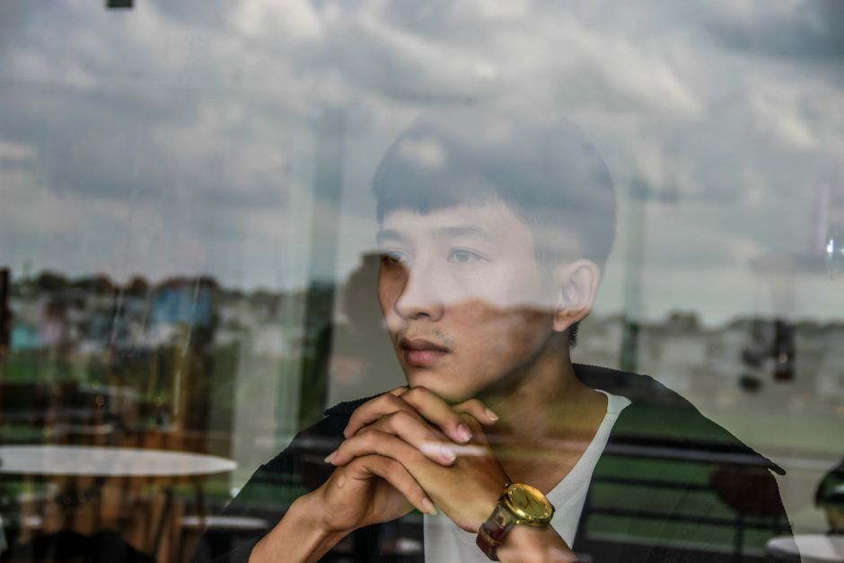 A man lost in thought, gazing out a window as he reminisces about women from his past.
