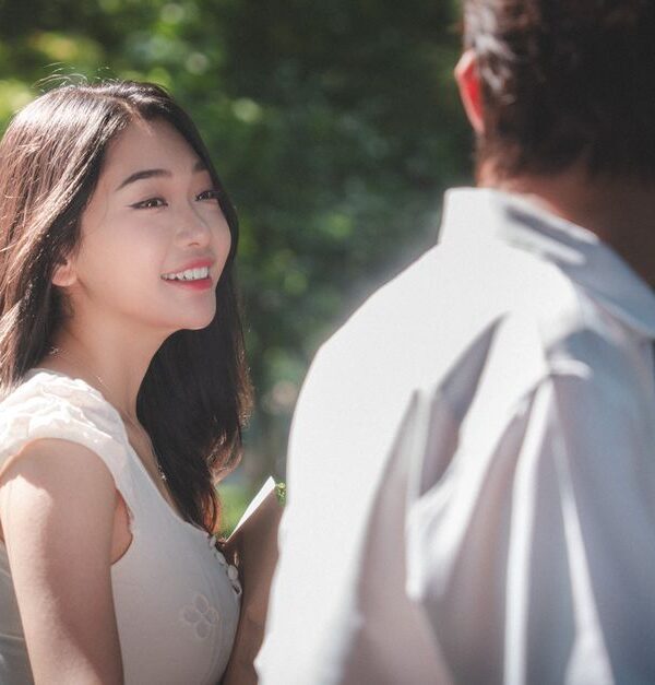A woman gazes happily at a man, hinting at the subtle signs of hidden affection in a budding relationship.