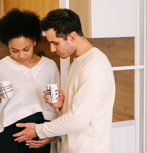 A caring man gently touches his pregnant partner's belly, showing one of the small things women secretly wish men would do more often.