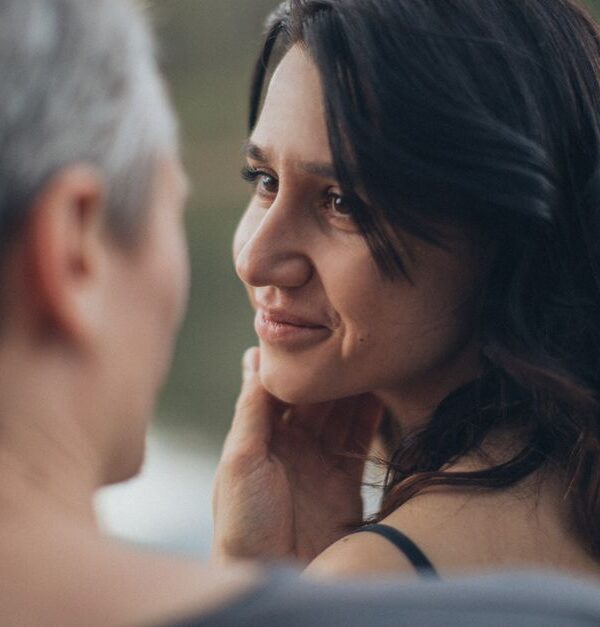 A woman shares a captivating, intimate gaze with a man, hinting at the magnetic pull that makes him miss her.