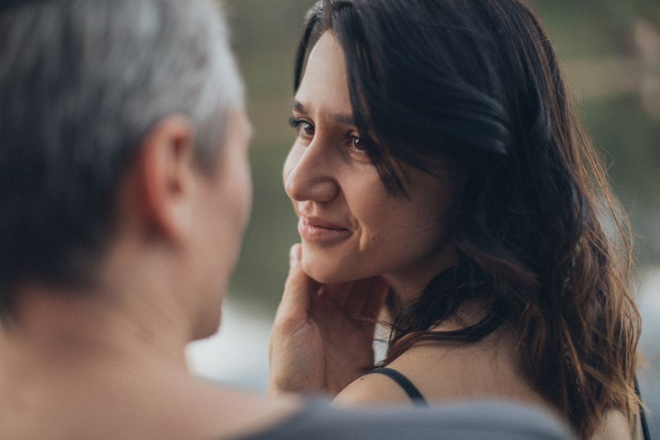 A woman shares a captivating, intimate gaze with a man, hinting at the magnetic pull that makes him miss her.