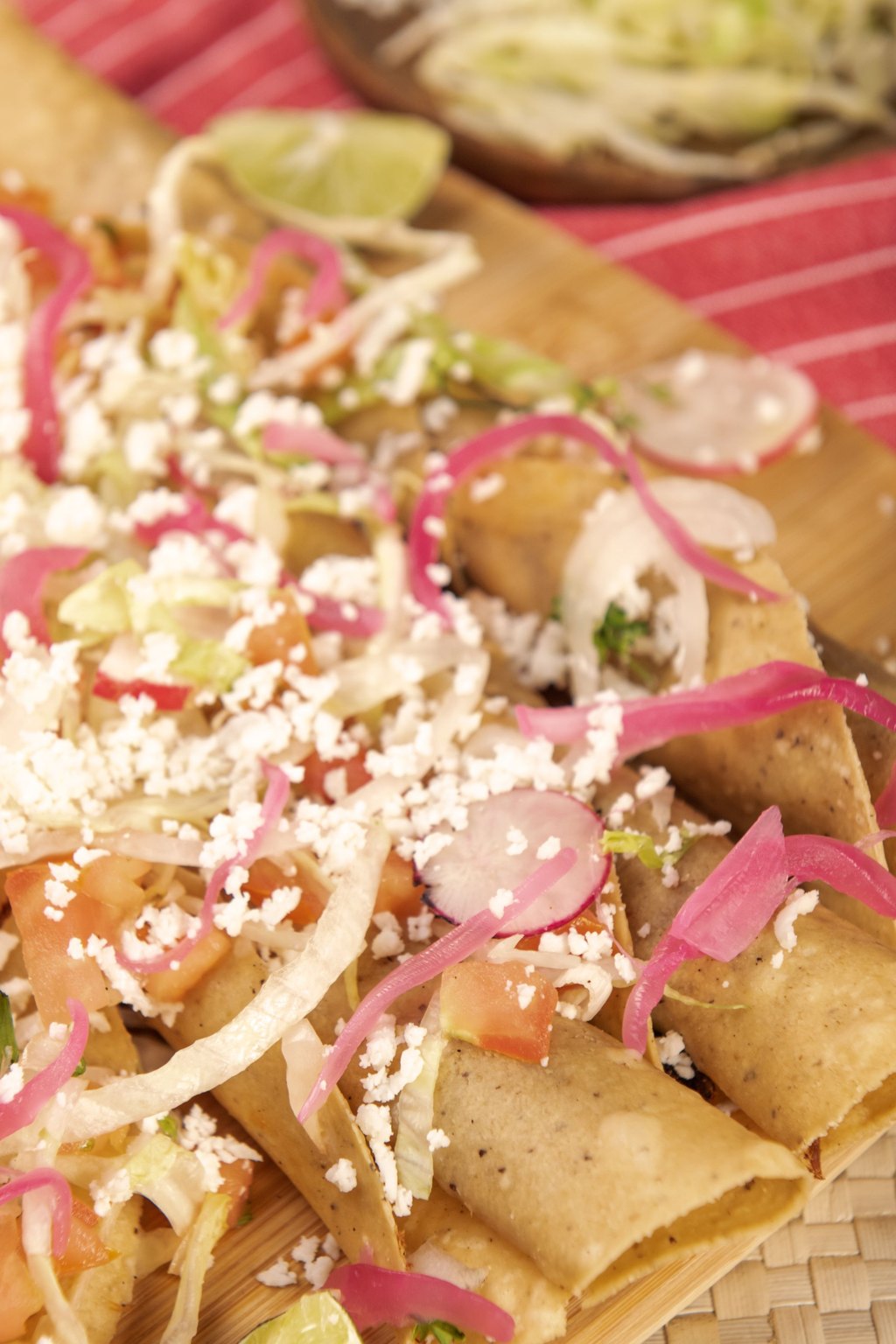Close up of crispy baked chicken taquitos