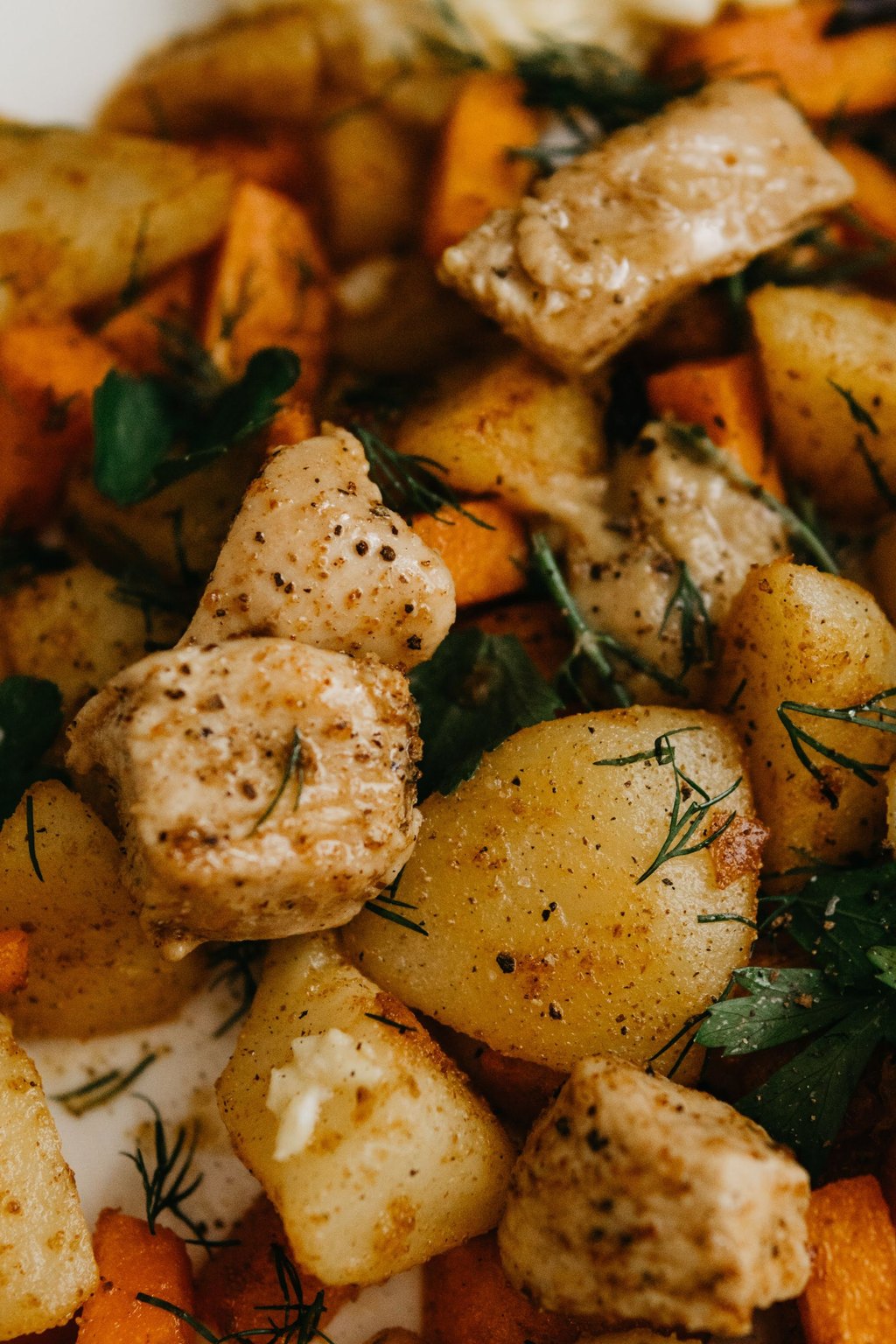 Close up of maple dijon chicken thighs and sweet potatoes