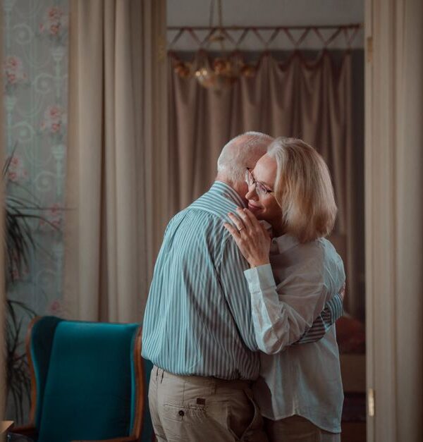 An older couple shares a tender embrace, reflecting the timeless marriage habits couples from the '60s still swear by