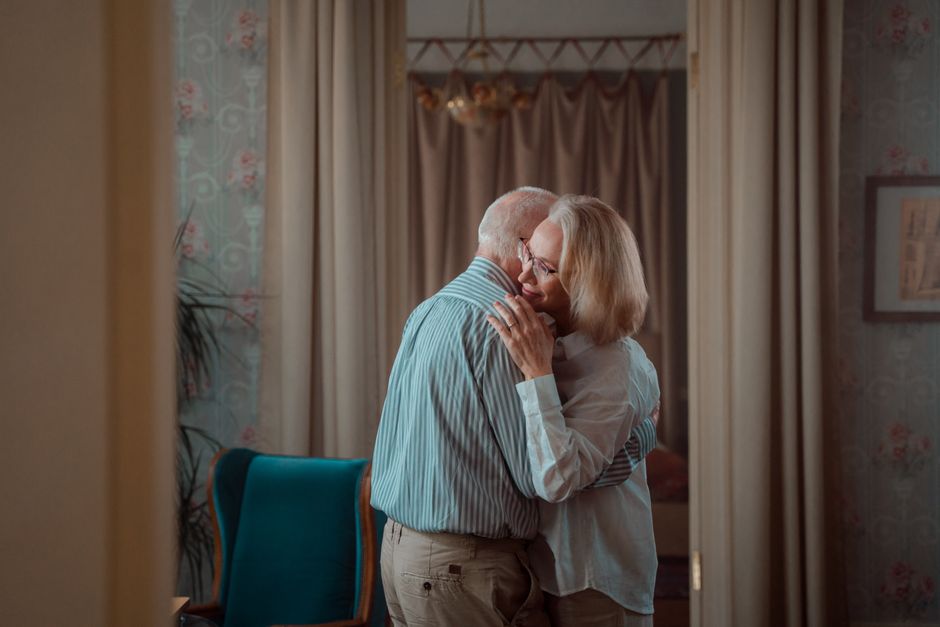 An older couple shares a tender embrace, reflecting the timeless marriage habits couples from the '60s still swear by