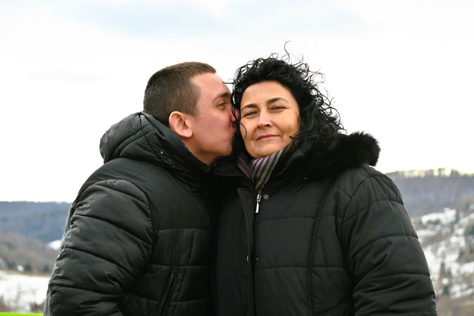 An older couple shares a tender moment outdoors, reflecting how people and relationships evolve over time together.