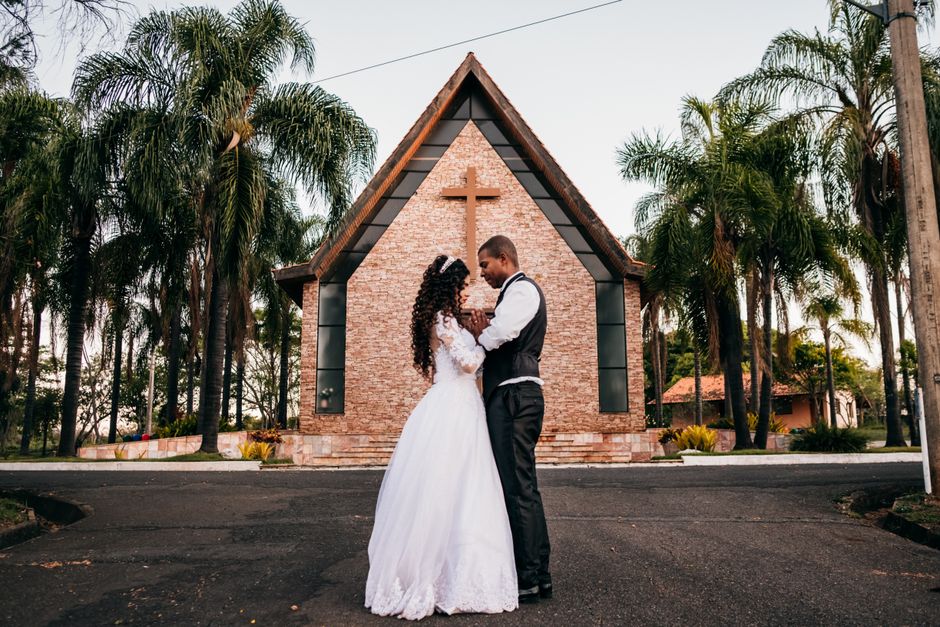 A newlywed couple shares a tender moment outside a chapel, reflecting on marriage and the choices that shape it.