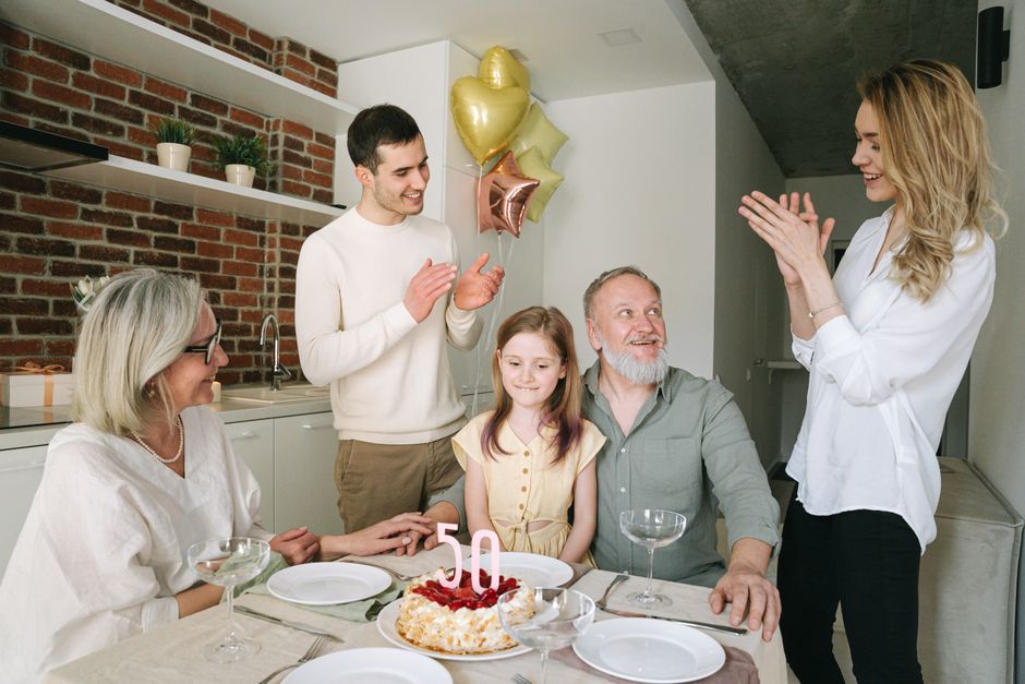 A woman's new extended family, including in-laws and a young relative, gathers together to celebrate a milestone occasion.