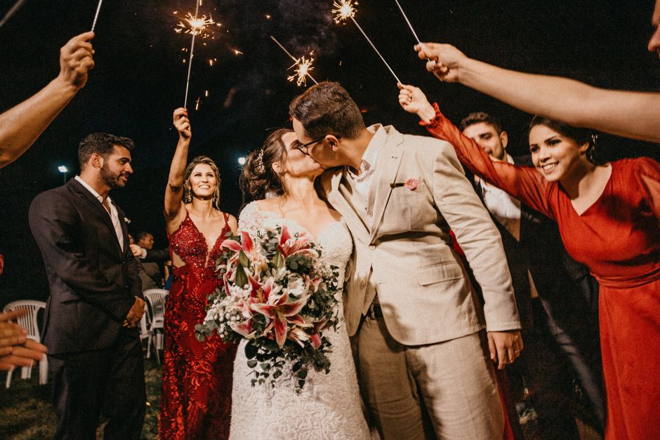 A newlywed couple kisses amid sparkling celebration, a reminder that the wedding day is just the party before the real marriage begins.