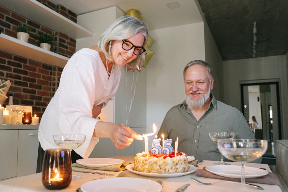 A long-married couple celebrates their 55th anniversary with cake and candlelight at home, a quiet tradition kept alive each year