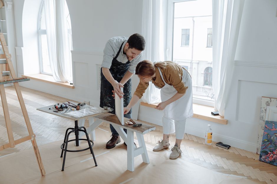 A couple builds a small wooden bench together, embracing the old-fashioned habit of sharing a hobby just like '60s couples did.