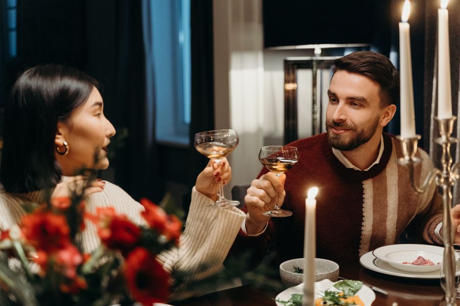 A couple enjoys a regular candlelit dinner date night together, a tradition carried over from '60s marriage habits.