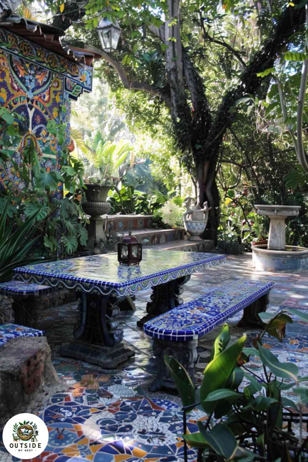 Gaudi-inspired mosaic tiled patio with lush foliage