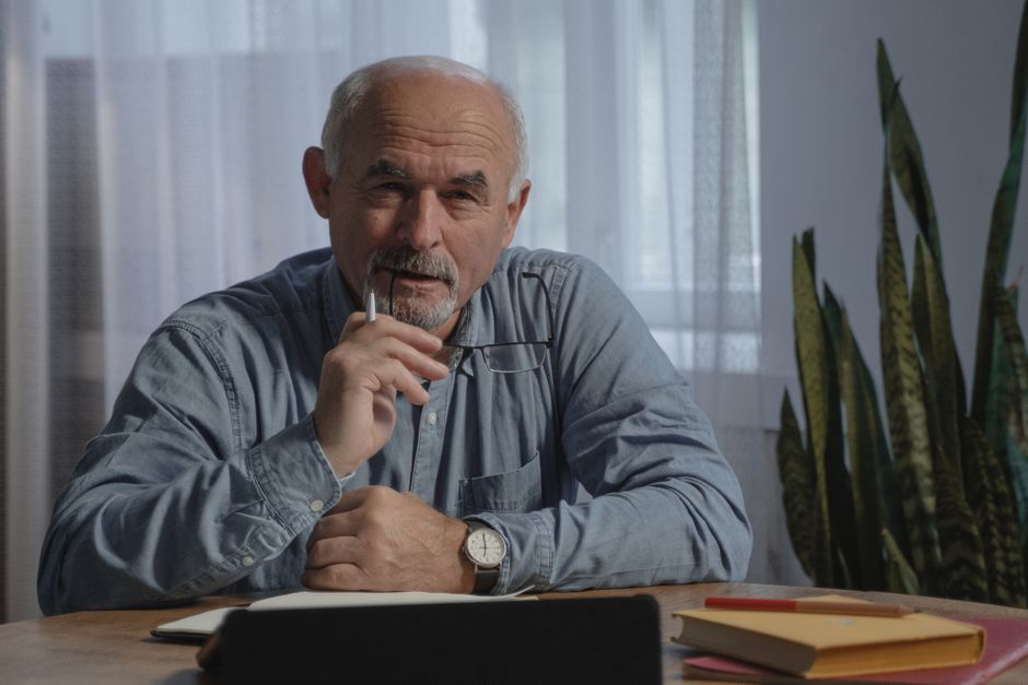 An older man pauses in quiet reflection, perhaps contemplating fears about retirement he rarely voices aloud.