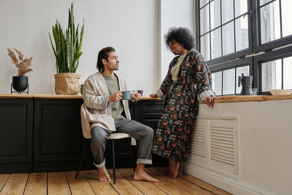 A couple sharing coffee and genuine conversation together, reflecting a man's desire to be asked about his day.