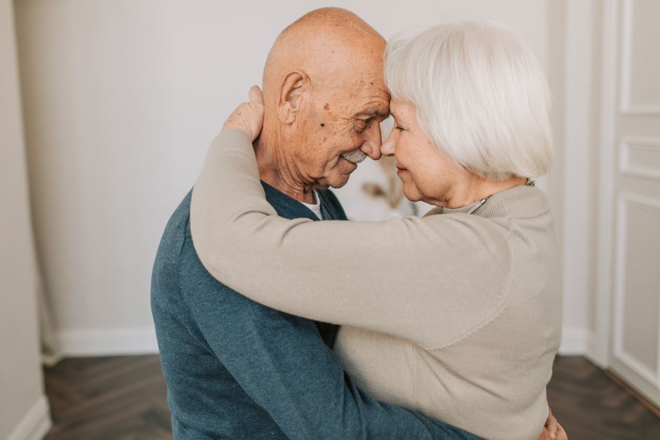 A husband and wife share a tender forehead-to-forehead moment of reconciliation and love.