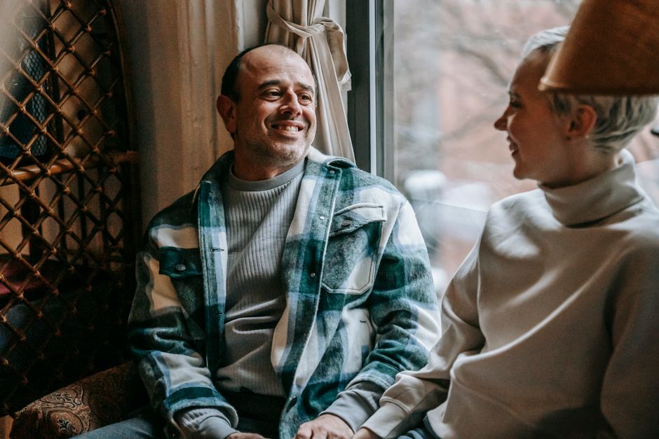 A wife smiling warmly at her husband as she shares something she appreciates about him.