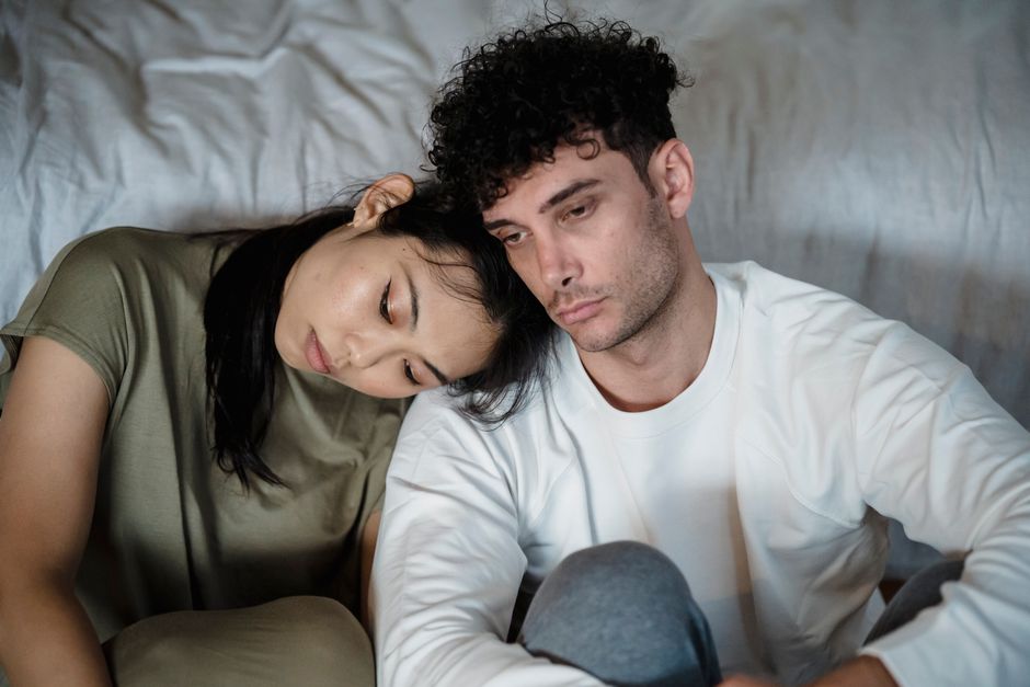 A man sits in comfortable silence as the woman he loves quietly leans her head on his shoulder.