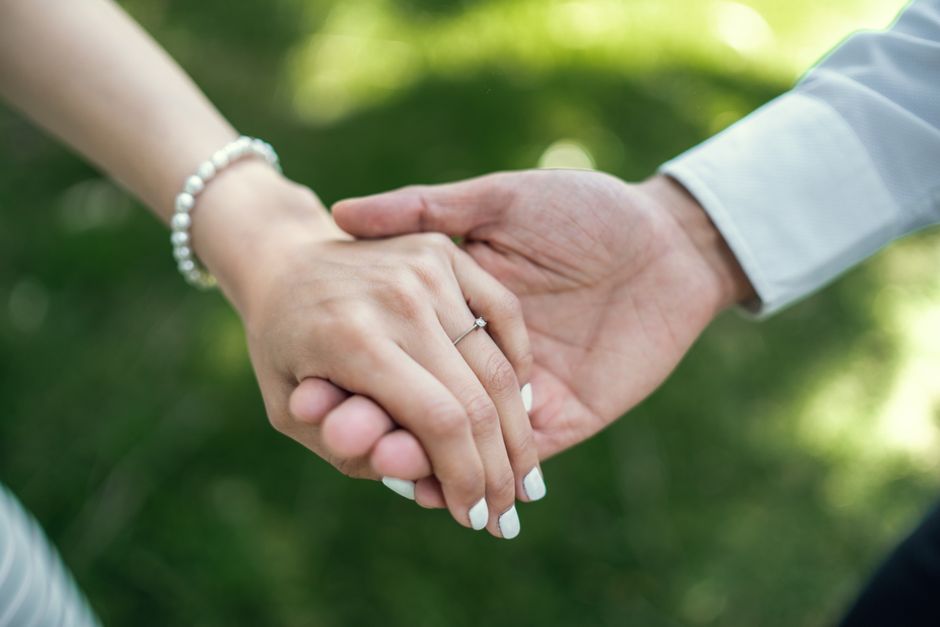 A couple gently holding hands, symbolizing trust and the quiet promises partners keep for each other.