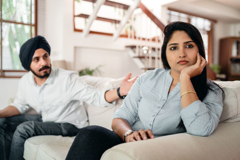 A man reaches out trying to console his frustrated partner, unsure how else to respond to her feelings.