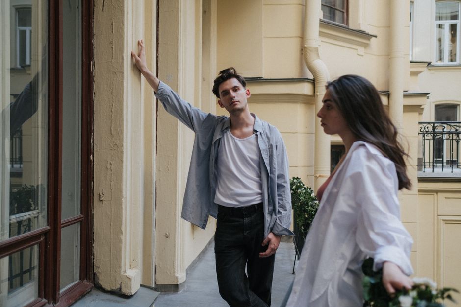 A man watches longingly as a woman walks away, symbolizing the one he let go too young to know better.
