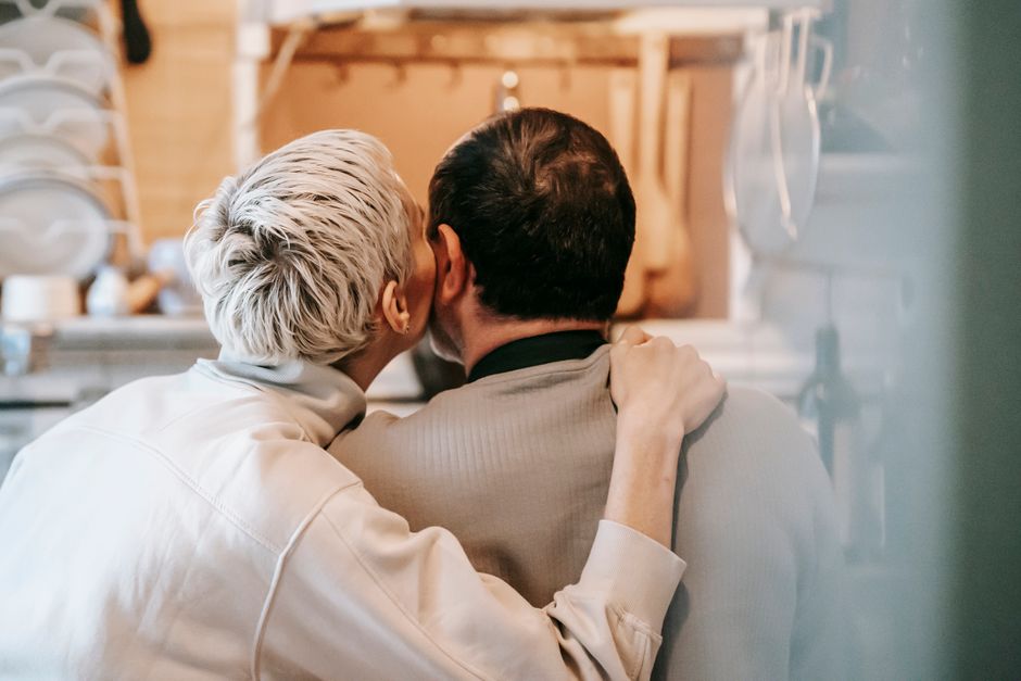 A woman tenderly embraces her partner, showing the quiet appreciation men often crave but rarely hear expressed.