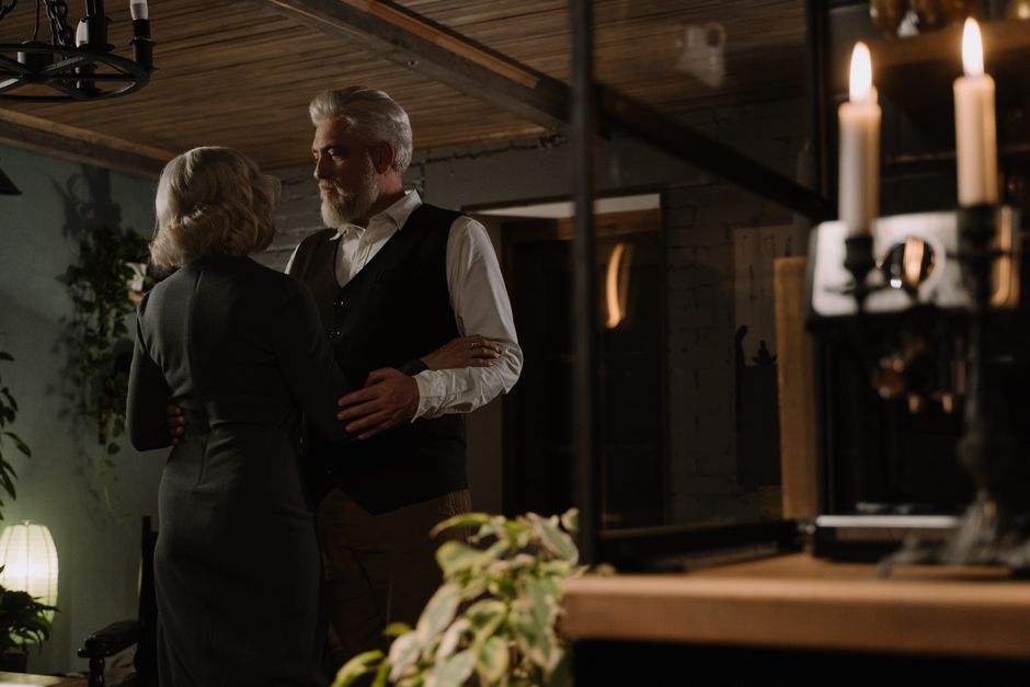 An older couple shares a close, tender embrace in candlelight, reflecting the deep communication and loyalty men over 50 value instead of silence.