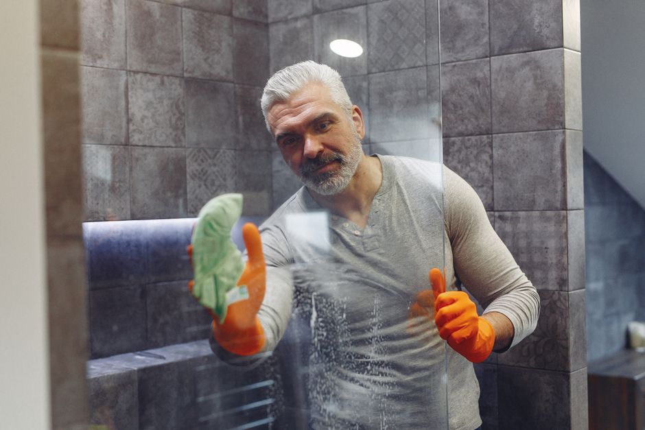 An older man cleaning up around the house, showing he takes pride in staying tidy and put-together.