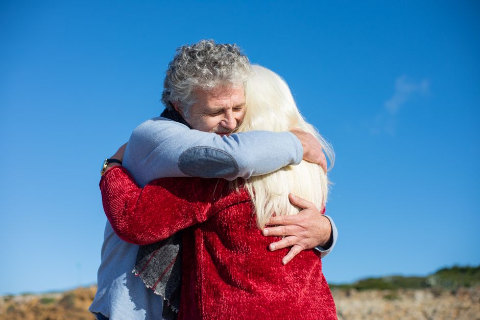 An older man lovingly embraces his partner, showing the forgiveness and devotion that keeps couples loyal for decades.