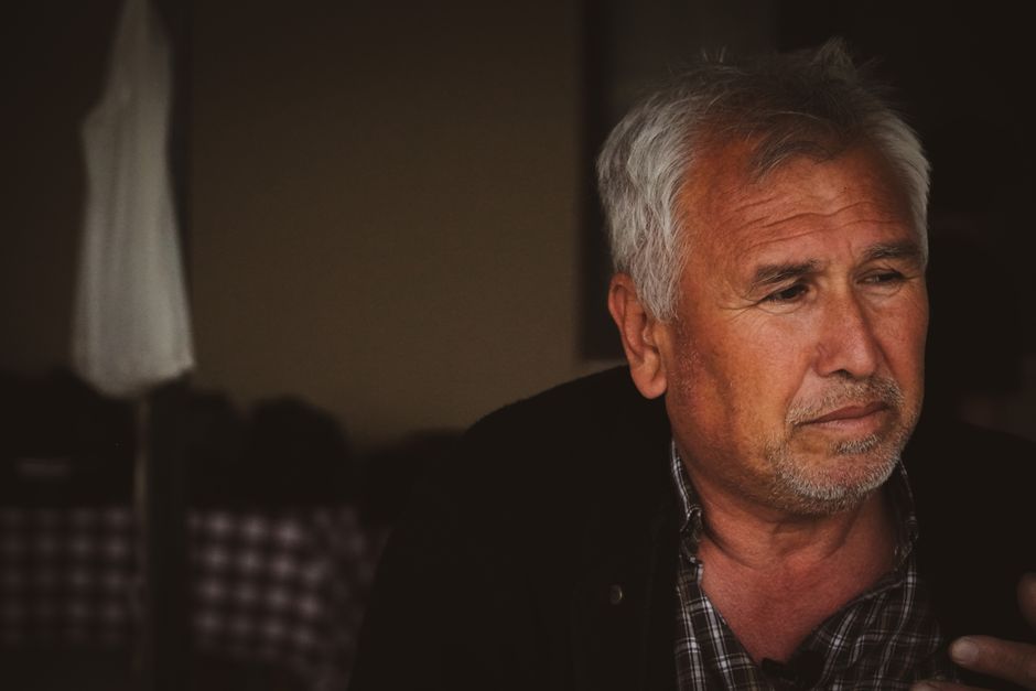 An older man waits patiently with a weary expression, illustrating the patience needed to sit through the boring parts of a relationship.