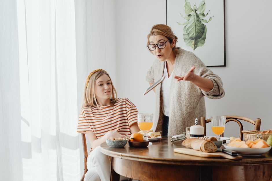 A mother confronts her adult daughter about money matters during breakfast, illustrating why parents should avoid commenting on their adult children's spending.