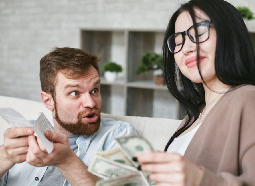 A woman smugly pockets cash while her partner reacts with shock and confusion, illustrating broken money promises.