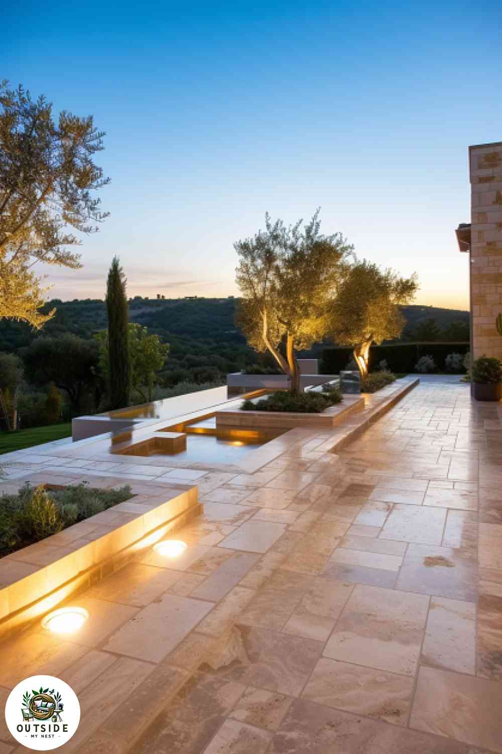 Mediterranean patio with travertine tiles and olive trees