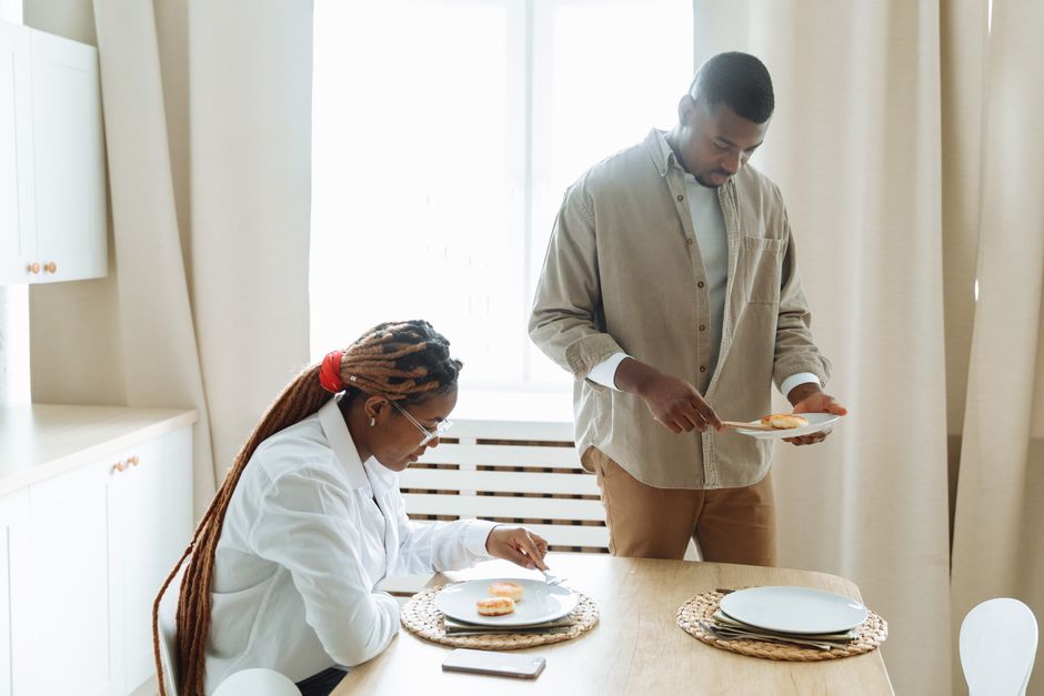 A couple sharing a quiet, routine breakfast together at home.